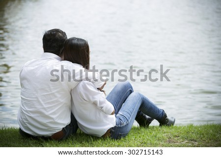 Couple kissing happiness fun. Interracial young couple embracing laughing on date. Asian couple on Thailand with the romance times