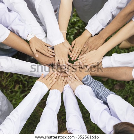 group of doctor or scientist team joining hands, bird\'s eyes angle view