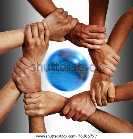 Small group of business people joining hands, bird\'s eyes angle view with globe.