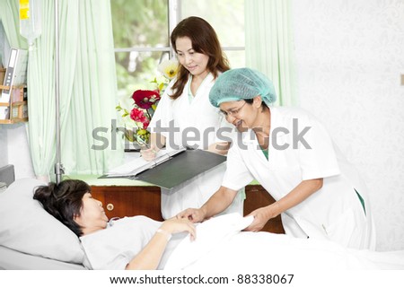 Portrait of a doctor with his co-workers talking with a patient
