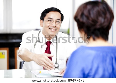 medical consultation. patient and doctor talking to a doctor\'s office