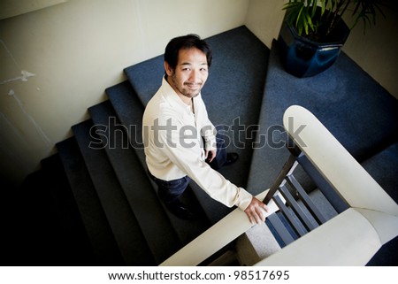 Businessman stepping up the stairs from