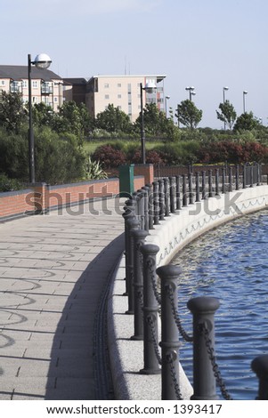 view of lakeside development showing lake,walled path with chain railing and properties