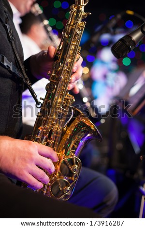 Photo of the male jazz saxophonist playing in sax