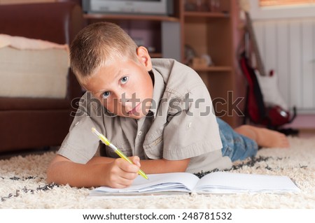 Young boy doing his homework at home - education