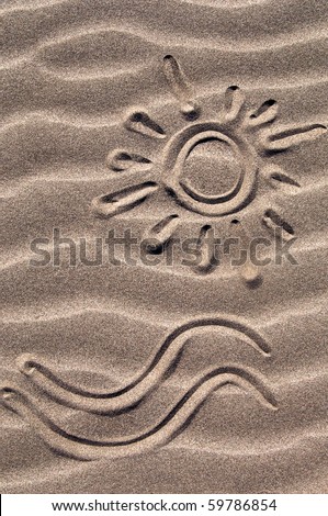 Sun and wave drawn in the sand on the beach