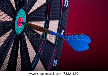 close up of an electronic dart board and blue arrow
