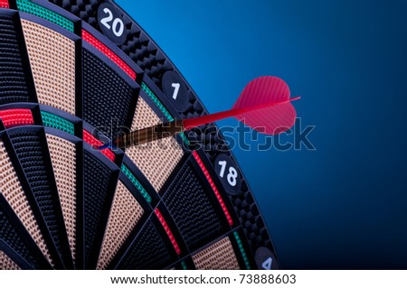 close up of an electronic dart board and red arrow