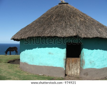blue earthen round house and donkey, South Africa coast