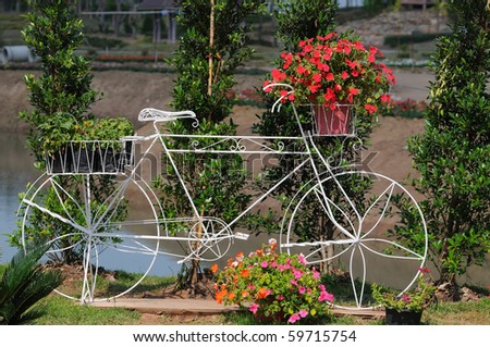 A bicycle built for a garden of ornamental flowers.