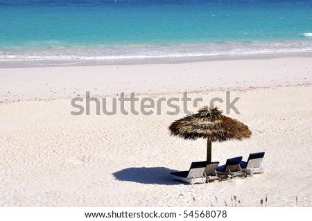 a beautiful beach with sun shade and sun chairs