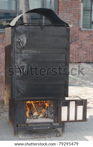 old black metal oven with fire door wide open