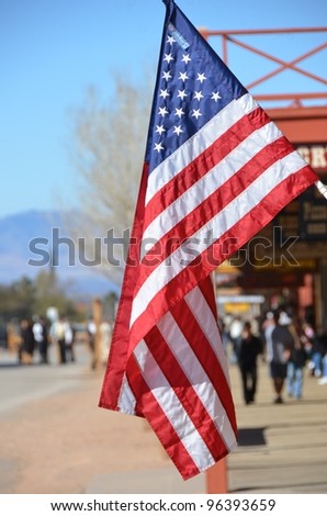 US flag with street scene in the background