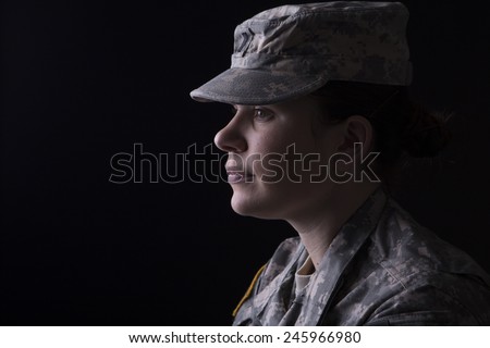 Military woman close up portrait, studio low key
