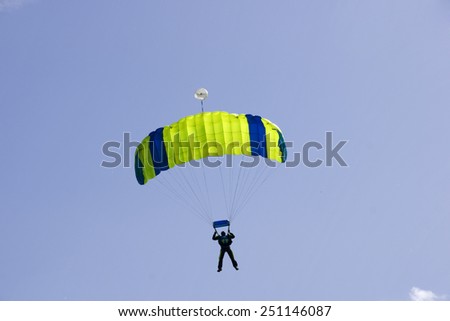 Parachutist jumping on a background of blue sky