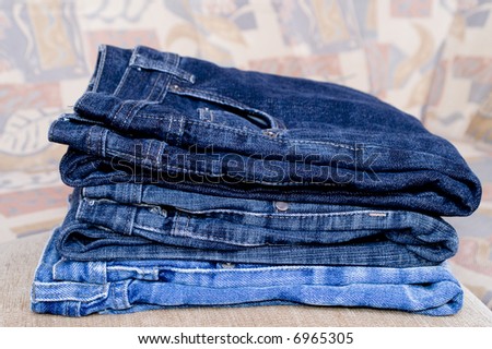 Pile of blue jeans trousers.