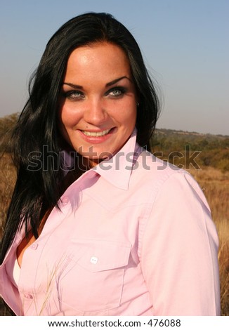 Woman standing with her blouse unbuttoned