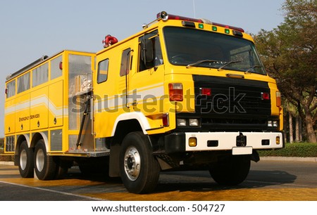 Yellow Fire Truck parked next to road