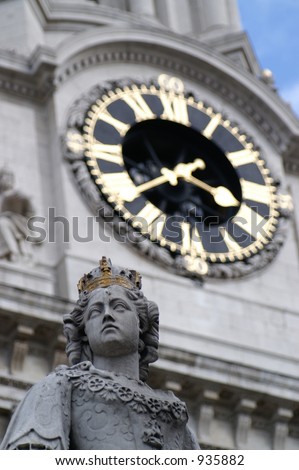 A statue and the clock of St. Paul\'s Cathedral, taken by long focal length to compress the 2 things together, making them look very closed.