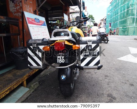 PENANG, MALAYSIA - MAY 8: Police Motorcycle park on the street at little india area on May 8, 2011. Georgetown, Penang, Malaysia.  The motorbike have 2 license plates in Malaysian and Thai