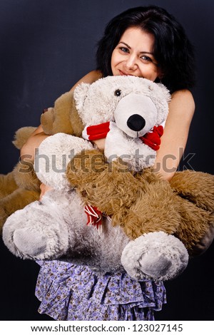 Cute girl posing at studio with teddy bear