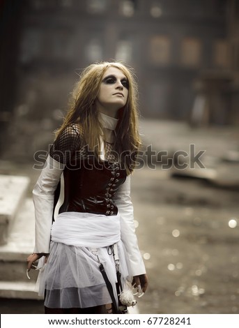 Cute gothic girl with face-art posing outdoors