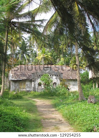 Old  colonial house influenced by Dutch architecture  and surrounded by palm trees,in Polhena town, Sri Lanka
