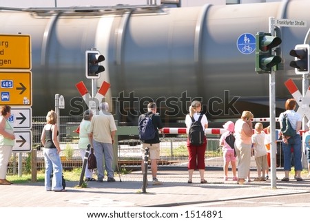 People waiting to cross rails