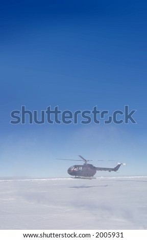 Helicopter hovering over snow