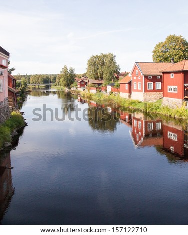 Red houses at a canal. . Houses and environment in Sweden.