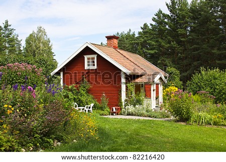 Beautiful summer cottage with flower in the garden.
