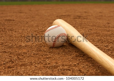 Baseball & Bat on the Infield Dirt