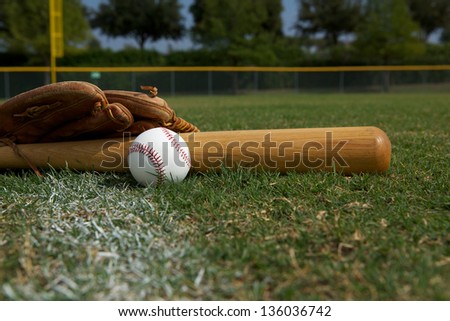 Baseball Bat and Glove on the grass with room for copy