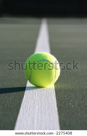 On the line!  Tennis ball on the court line