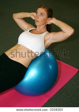 Woman doing a situp on a medicine ball