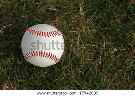 Baseball on grass with room for copy