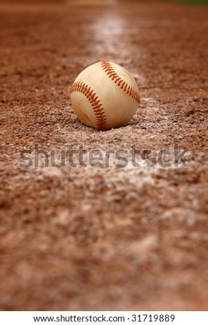 Isolated baseball on the faded chalk line