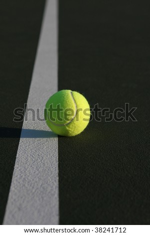 Tennis ball and the court line fading away