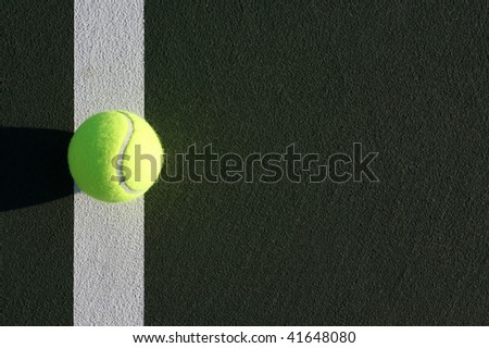 Tennis Ball on the court line with copy space on the right side