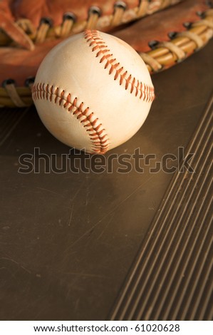 Baseball and a glove on the bench with room for copy