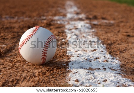Baseball on the field near the chalk line