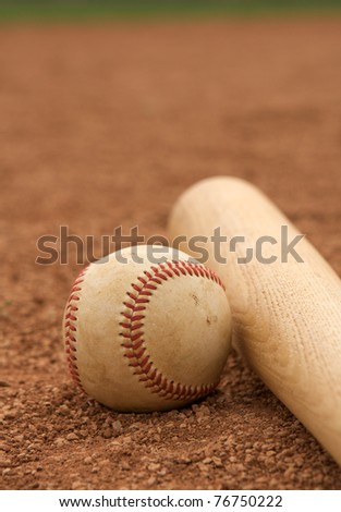 Baseball & Bat on the infield dirt with room for copy