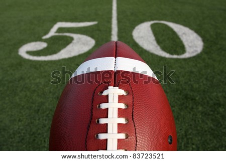 American Football with the Fifty Yard Line Marker Beyond