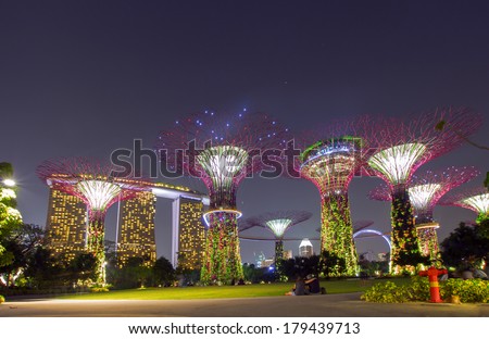 Futuristic view of amazing illumination at Garden by the Bay on Mar 02, 2014 in Singapore. Night light show at Supertree Groveis is main Marina Bay Sands district tourist attraction