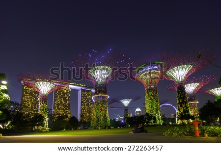 Futuristic view of amazing illumination at Garden by the Bay on Mar 02, 2014 in Singapore. Night light show at Supertree Groveis is main Marina Bay Sands district tourist attraction