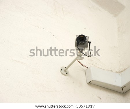 Security camera on a wall outside building