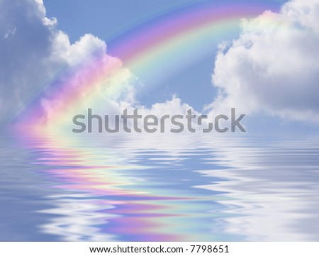 Blue sky with rainbow and clouds reflected in the water