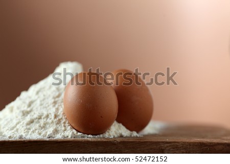 eggs and flour ready for a new receipt on a wooden table in the kitchen