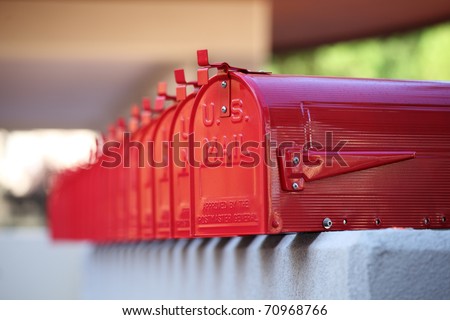 glossy red mailbox repetition in american style and blurred background for mails