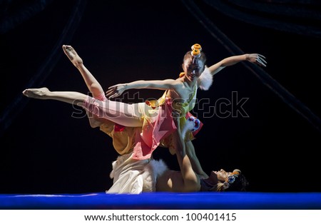 CHENGDU - OCT 17: Tibetan national dancers perform folk dance on stage at JINCHENG theater on Oct 17, 2011 in Chengdu, China.